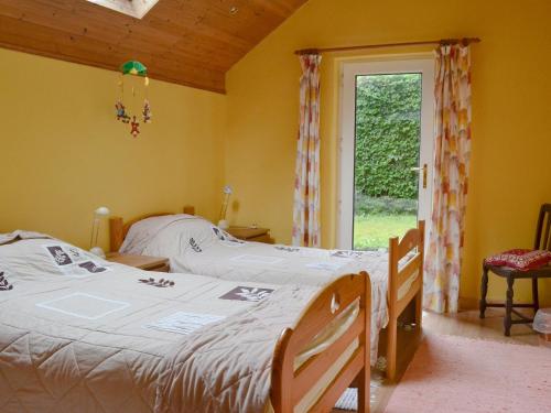 a bedroom with a bed and a window at Dye Mill Cottage in Moffat