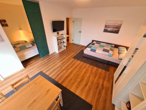 a large room with two beds and a television at 1,5 Zimmer Apartments mit traumhafter Aussicht in Bad Kissingen