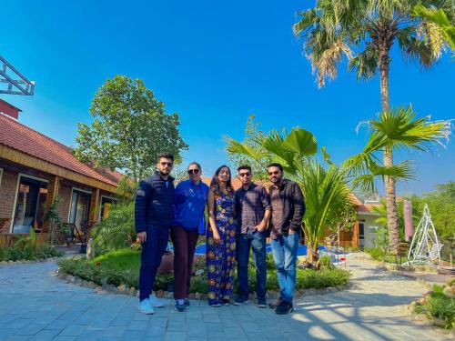 a group of people posing for a picture in front of a house at D&D riverside Homestay in Xuân Sơn