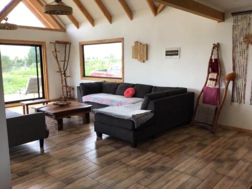 a living room with a couch and a table at Bello Horizonte Lodge in Villarrica