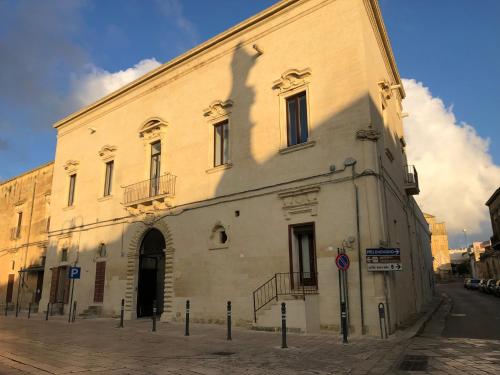 a large white building on the side of a street at La Dimora Del Barone in Vernole