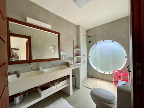 a bathroom with a sink and a mirror at La Réserve Design Villas in Pipa