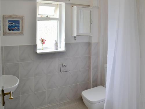 a bathroom with a toilet and a sink and a window at Marlott -17134 in West Orchard