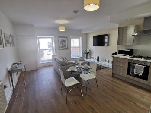 a living room with a couch and a table at Griffin Apartments in Nottage