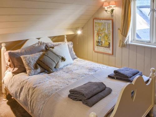 a bedroom with a bed with towels on it at Swallows Nest in Saint Lawrence