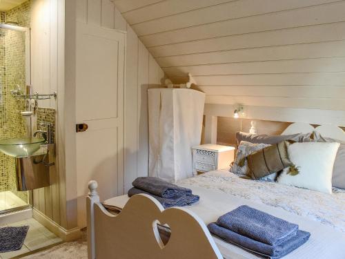 a bedroom with a bed with towels on it at Swallows Nest in Saint Lawrence