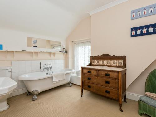 a bathroom with a tub and a sink and a bath tub at Hartrees House in Silecroft