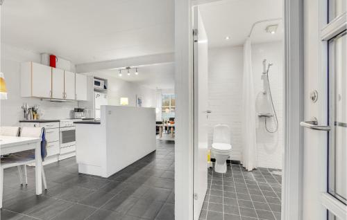 a kitchen with a white refrigerator and a toilet at Gorgeous Apartment In Bindslev With Wifi in Bindslev