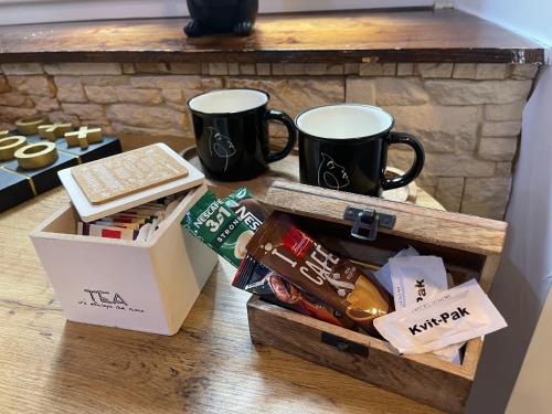 a table with two coffee mugs and a box of cookies at Old Town Center Zadar in Zadar