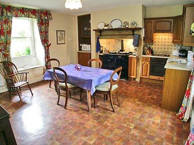 a kitchen with a table and chairs in a kitchen at Low West in Hexham