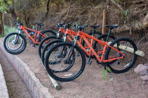 a row of bikes parked next to a fence at Casa Solcor Boutique Bed & Breakfast in San Pedro de Atacama
