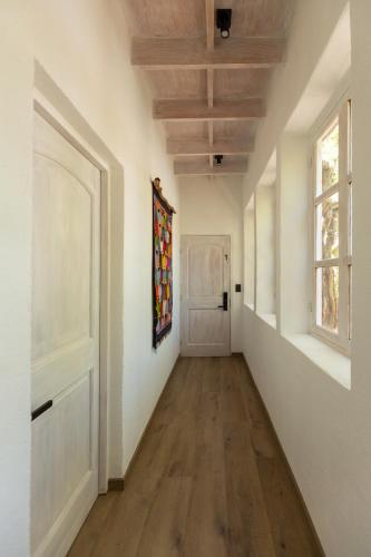 an empty hallway with a door and a painting on the wall at Casa Solcor Boutique Bed & Breakfast in San Pedro de Atacama