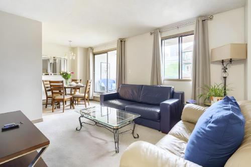 a living room with a couch and a table at Entire Condo Downtown, walk to BMO & Stampede, Parking, 1,5 hrs to Banff in Calgary