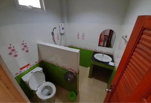 a small bathroom with a toilet and a sink at Pantip Residence in Nan