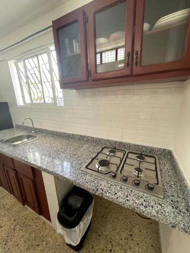a kitchen with a stove and a counter top at 2cristian suit in Los Frailes