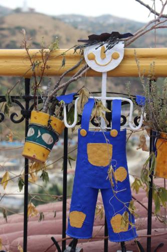 apron hanging on a fence with a tree at Hotel Gernika in Chefchaouene