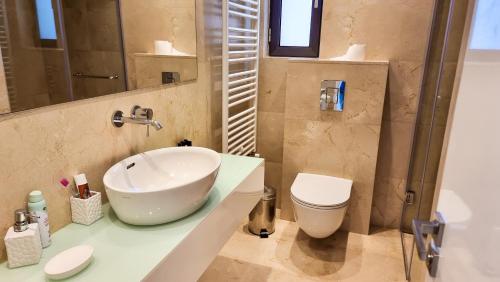 a bathroom with a sink and a toilet at Leto 13 Villa in Paphos City