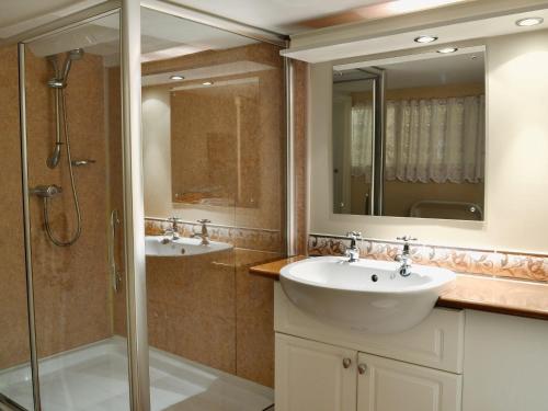 a bathroom with two sinks and a shower at Pats Cottage in Dore