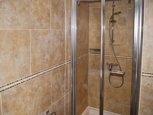 a shower in a bathroom with a glass shower stall at Chaucers Nook in Wigan
