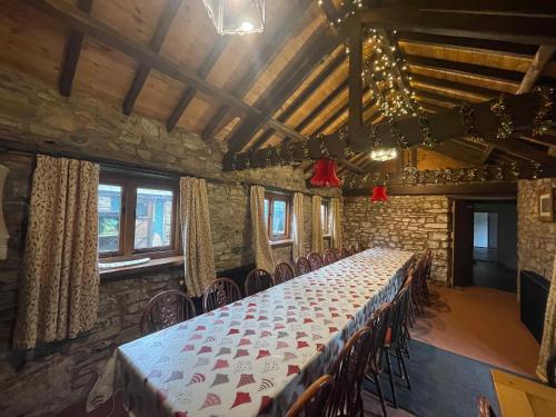 a long table in a room with chairs at Duvale Priory - 9985 in Bampton