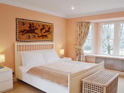 a bedroom with a white bed and a window at Haugh House in Aberlour