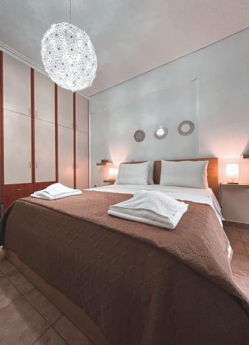 a bedroom with a large bed with a chandelier at Filanthis inn in Kalamata