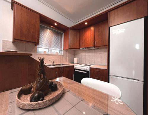 a kitchen with a table with a bowl of vegetables on it at Filanthis inn in Kalamata