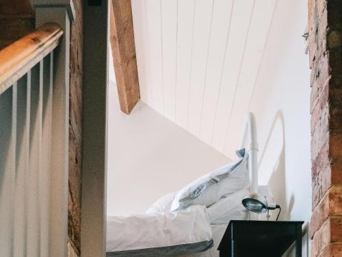 a staircase in a room with a white wall at Southfield Cottage in Braunston