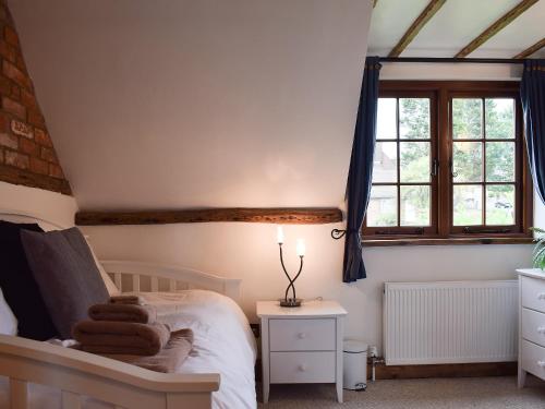 a bedroom with a bed and a window at The Old Bakery in Wendover