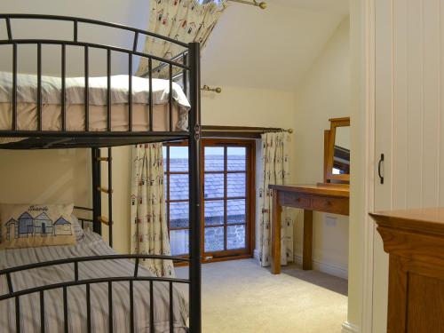 a bedroom with a bunk bed and a desk at Tawny Owl -27819 in Westleigh