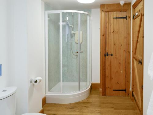 a bathroom with a shower and a toilet in it at The Bridles -26718 in North Willingham