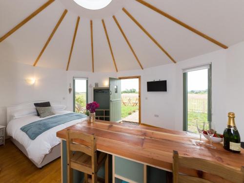 a bedroom with a bed and a wooden table at Bay in Wootton Bridge