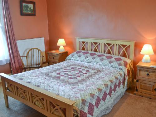 a bedroom with a bed with a quilt on it at Suffolk House Annexe in Harrow on the Hill
