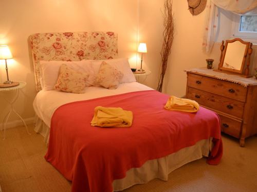 a bedroom with a bed with two towels on it at Fireside Cottagewindermere in Windermere