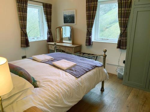 a bedroom with a bed with two towels on it at Dipper in Malham