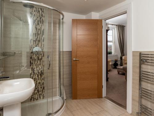 a bathroom with a shower and a sink at Oddicombe, Torquay in Torquay