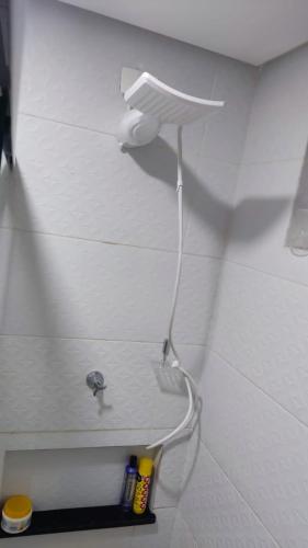 a bathroom with a toilet paper holder on the wall at Mirantes caminho do mar in Parnamirim