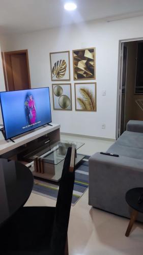 a living room with a tv and a couch at Mirantes caminho do mar in Parnamirim