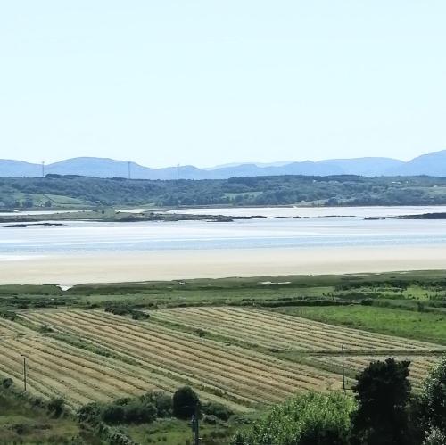 a view of a beach and a body of water at Maggie's House in Glenties