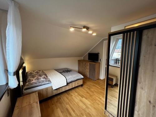 a small bedroom with a bed and a balcony at Pokoje gościnne BROKAT in Szczyrk