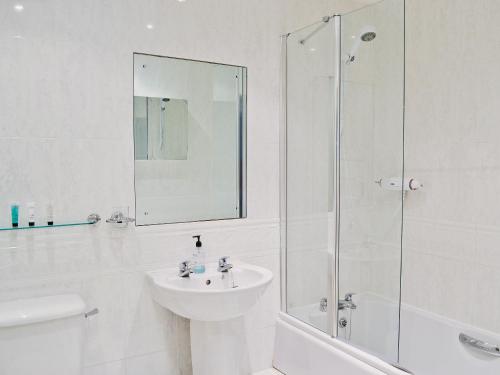 a white bathroom with a sink and a shower at Martin's Court in York