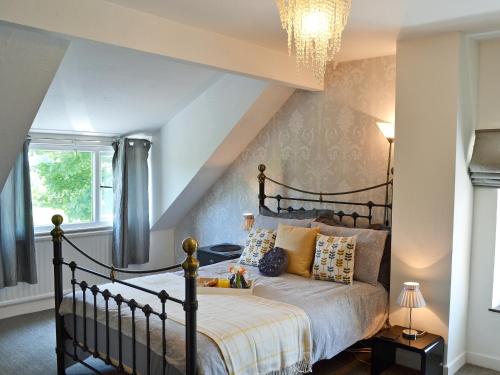 a bedroom with a bed and a chandelier at Didfa - 27912 in Llangoed