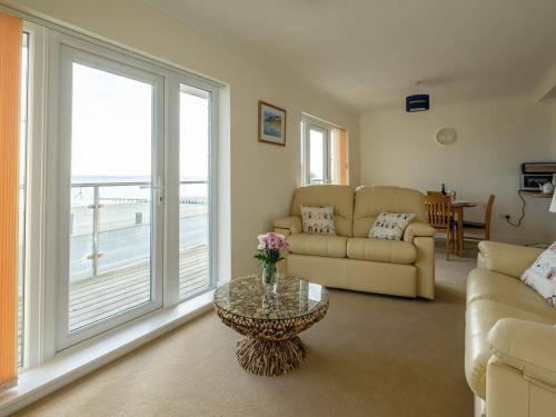 a living room with a couch and a table at Culver View in Shanklin