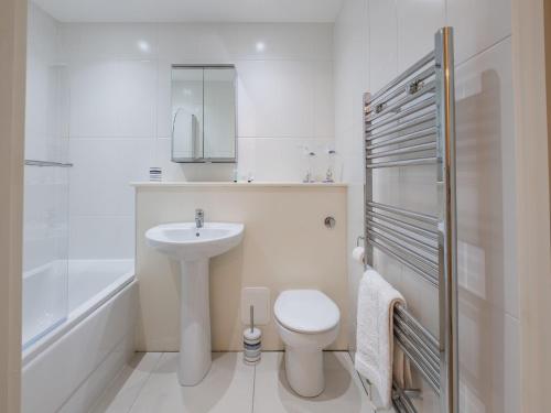a white bathroom with a sink and a toilet at Culver View in Shanklin