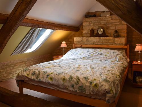 a bedroom with a bed in a attic at Picket Piece Cottage in Chadlington