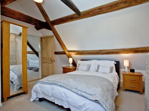 a bedroom with a large bed and a large mirror at Elizabethan House in Castletown