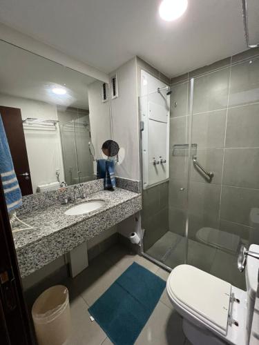 a bathroom with a shower and a sink and a toilet at Rio Centro Stay in Rio de Janeiro