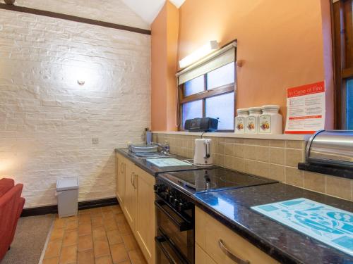 a kitchen with a stove and a counter top at The Old Stables in York