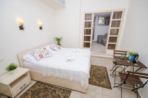 a bedroom with a bed and a table and chairs at The Spirit Of Tzfat Villa in Safed