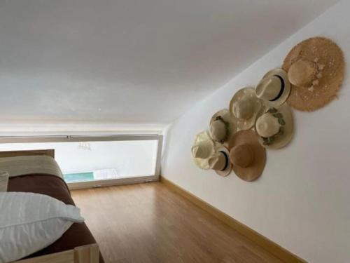 a bedroom with pots and pans on the wall at Apartamento en primera línea de playa in El Rompido